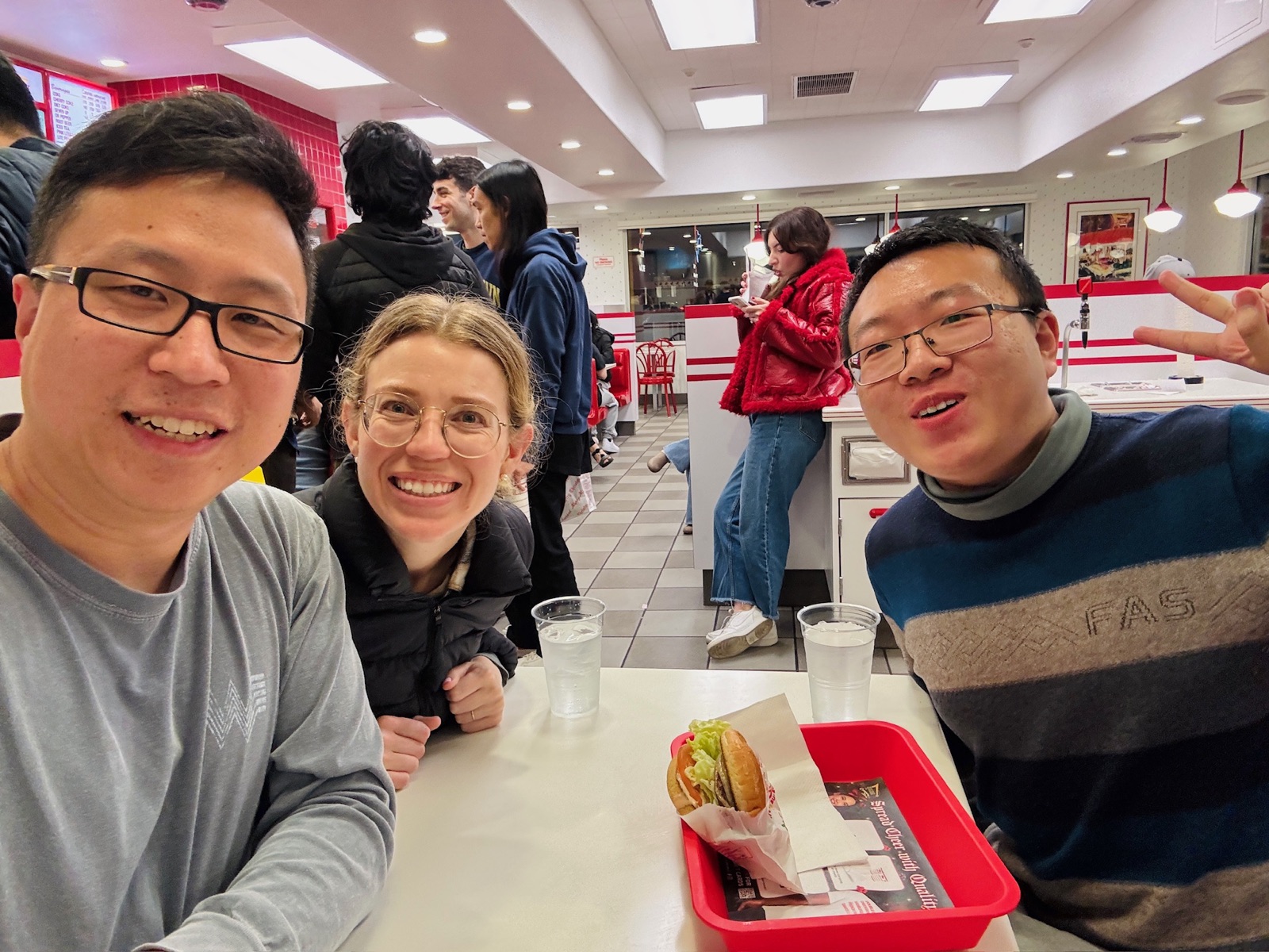 Shenghan Mei and two ISMP mentors at a table in a burger restaurant